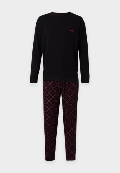 Haut noir à manches longues avec petit logo rouge "HUGO" et pantalon noir assorti avec motif quadrillé diagonal rouge et texte "HUGO".