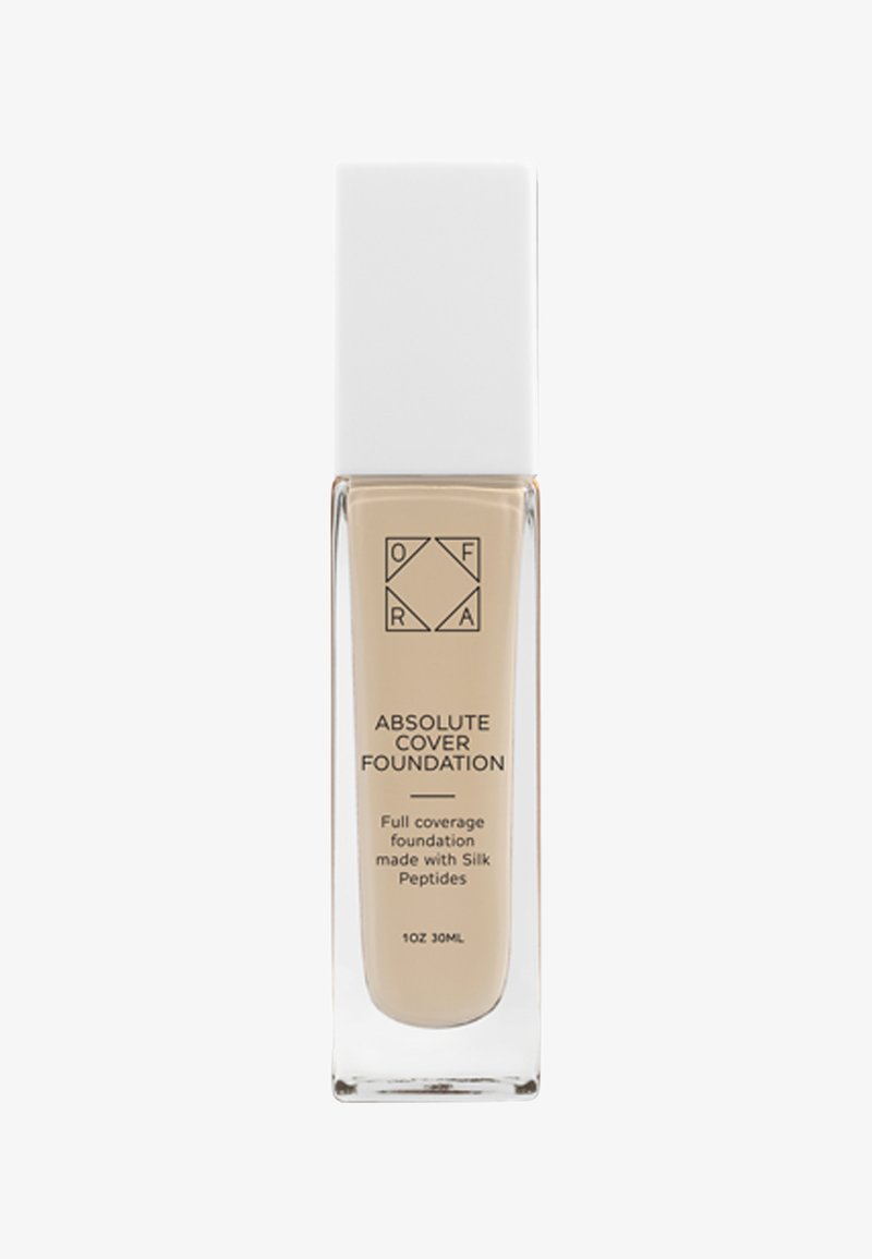 Klare Glasflasche mit einem weißen rechteckigen Deckel, gefüllt mit einer hellbeigen Flüssigfoundation, beschriftet mit "Absolute Cover Foundation."