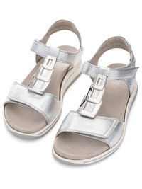 Silver leather open-toe sandals with adjustable ankle and front straps, cushioned beige footbed, and low white sole for comfort.