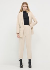Calliope CON RISVOLTO EFFETTO  - Pantalon classique - bianco