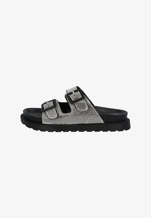 Schwarze Rutschsandalen mit zwei breiten Riemen, die mit silbernen Strasssteinen verziert sind. Texturierten Gummisohle sorgt für Halt und Langlebigkeit.