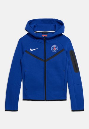 Blauer Nike Kapuzenpullover mit Reißverschluss und Paris Saint-Germain-Logo auf der Brust, schwarzem Reißverschluss und Reißverschlusstasche am linken Ärmel.