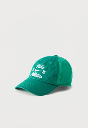 Casquette de baseball Nike verte avec texte brodé blanc « Nike 72 Athletics » et logo sur le devant, présentée sur un fond uni clair.