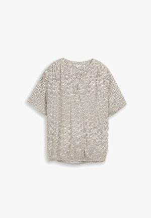 Blouse beige à manches courtes avec motif abstrait de lignes noires, encolure en V avec patte de boutonnage, posée à plat sur fond blanc.