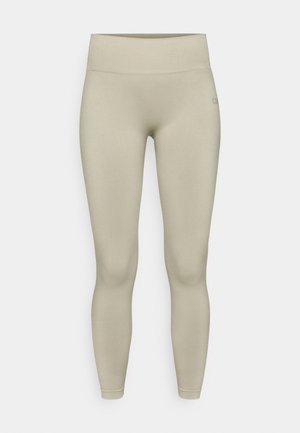 Lyse beige leggings med en glat, strækbar tekstur, høj talje og en tætsiddende pasform, der har minimal branding på taljebåndet.