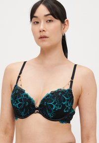 Sutiã de renda preta com bordados florais em verde-azulado, design decotado, alças ajustáveis e detalhes em metal dourado para um toque extra.