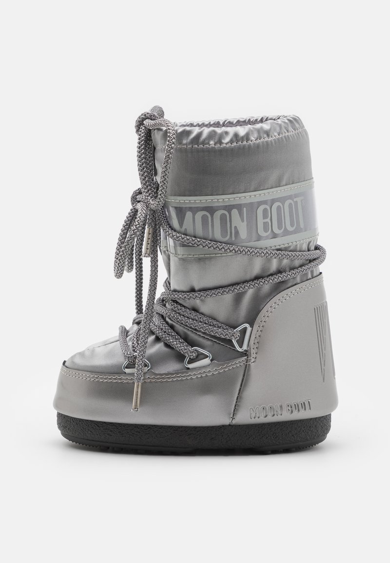 Silver waterproof moon boot with textured surface, padded top, adjustable laces, and rubber sole, featuring printed "MOON BOOT" branding.