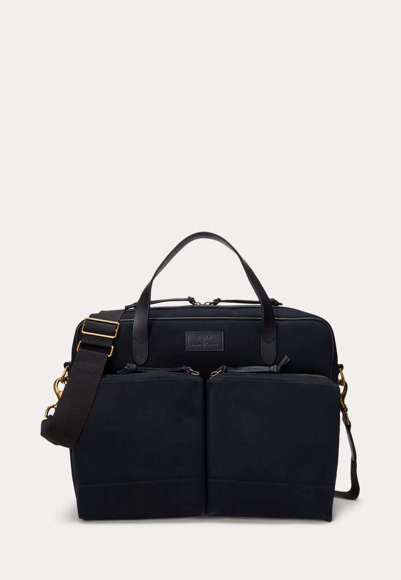 Saco de tecido preto com acentos em pele, apresentando dois bolsos frontais com zíper, alças duplas e uma alça de ombro destacável.