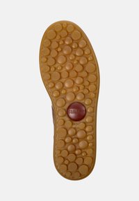 Brown rubber shoe sole featuring a dotted texture with varying sizes, a circular logo at the center, and a size marking of 42.