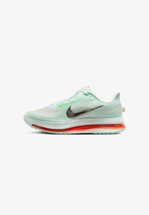 Mint green athletic shoe with a mesh upper, black Nike swoosh, and red air cushioning. Features a textured sole and light lacing system.