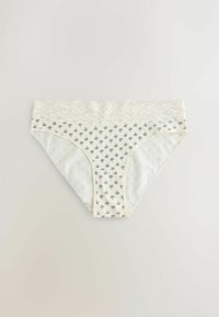 Fehér női bikini alsónemű fekete pókmintával és széles csipkés derékrésszel, világos háttéren lefektetve.