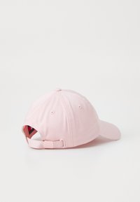 Gorra de béisbol rosa con visera curva, banda ajustable en la parte posterior y una textura de tela suave. El panel trasero tiene agujeros de ventilación.