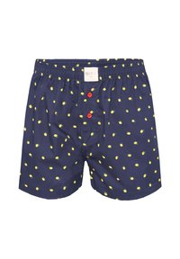 Boxer navy blu con motivo di limoni, dotati di cintura elastica e due bottoni rossi sul davanti. Materiale in cotone morbido.