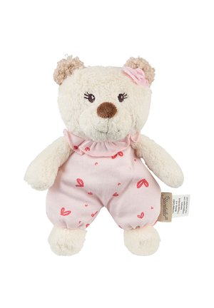 Small cream-colored teddy bear with curly ears, wearing pink heart-patterned romper and a pink fabric flower on its head.