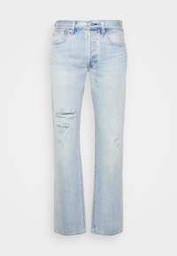 Light blue denim jeans with a straight fit, featuring distressed patches and frayed hems. Subtle fading and classic hardware accents.