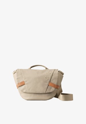 Beige shoulder bag with a textured surface, featuring a top handle, adjustable strap, and a brown leather accent on the flap.