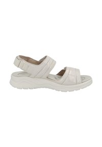 White sandals with two wide straps and a rear adjustable buckle. Textured upper with a soft finish, resting on a rubber sole with a wavy design.