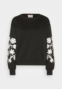 Sweat-shirt noir à manches longues avec broderie florale blanche sur les deux manches et poignets et ourlet côtelés.