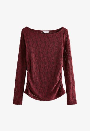 Top lungo bordeaux a maniche con pizzo e motivo floreale, caratterizzato da un ampio scollo e dettagli arricciati sui lati per una texture aggiuntiva.