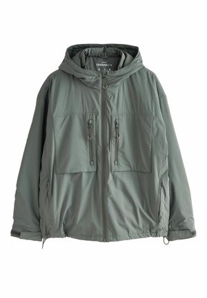 Grüne isolierte Jacke mit Kapuze, zwei Fronttaschen mit Reißverschlüssen und elastischen Bündchen. Hergestellt aus glattem, leichtem Material.