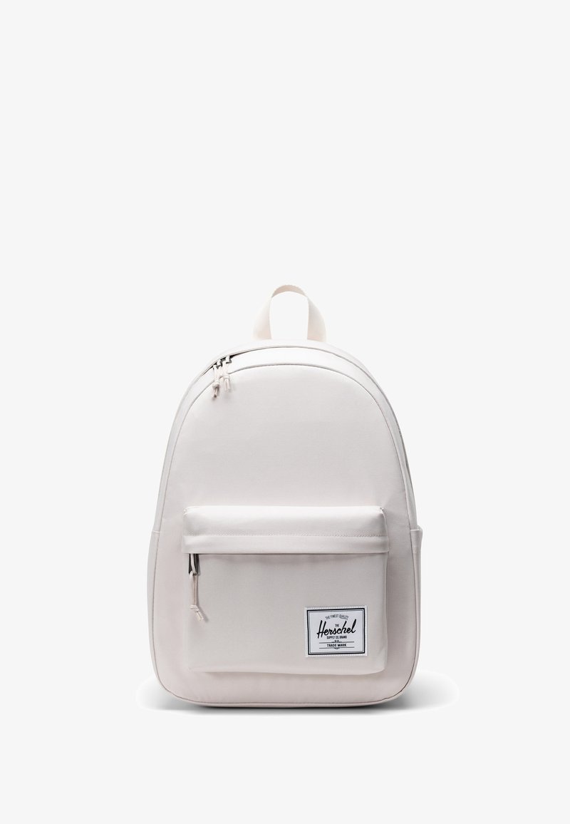 Zaino beige chiaro realizzato in tessuto resistente, caratterizzato da una forma arrotondata, tasca frontale con zip e maniglia superiore per il trasporto. Logo Herschel visibile.