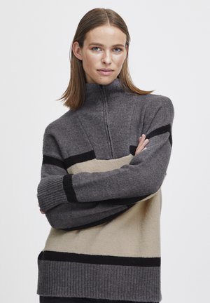 Grey and beige color-blocked pullover with a high collar, ribbed cuffs, and a textured knit pattern. Features black horizontal stripes.