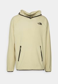 Beige The North Face fleece hoodie med kenguruficka, svarta dragkedjedetaljer, elastiska ärmslut och logotyp på vänster bröst.