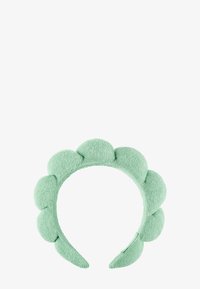 Myk, polstret mintgrønn hodebånd med avrundede, pute-liknende seksjoner jevnt fordelt langs toppen og sidene.