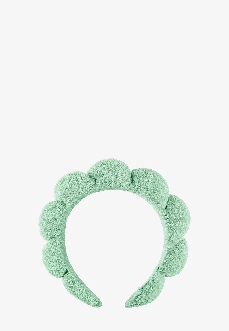 Myk, polstret mintgrønn hodebånd med avrundede, pute-liknende seksjoner jevnt fordelt langs toppen og sidene.