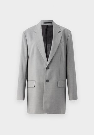 Grauer Blazer mit einer Schlitzöffnung, zwei aufgesetzten Taschen und zwei Knöpfen. Texturiertes Gewebe mit einem glatten Innenfutter. Mit Revers.