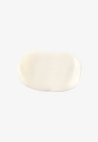 Vit krämig produkt i en oregelbundet oval form med en slät textur, som reflekterar ljus något utan synliga mönster eller accenter.