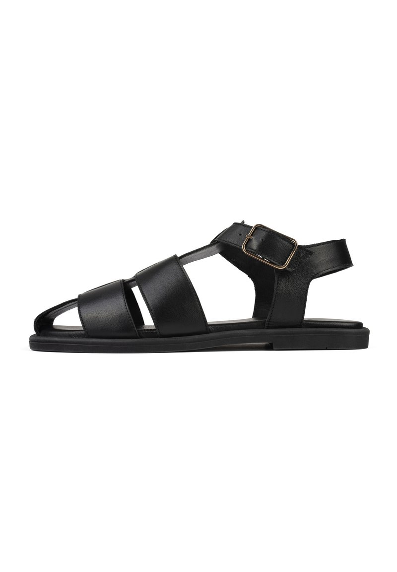 Sandal in pelle nera con tre fasce larghe e cinturino alla caviglia. Suola piatta, design con punta aperta, texture liscia e minime rifiniture in metallo.