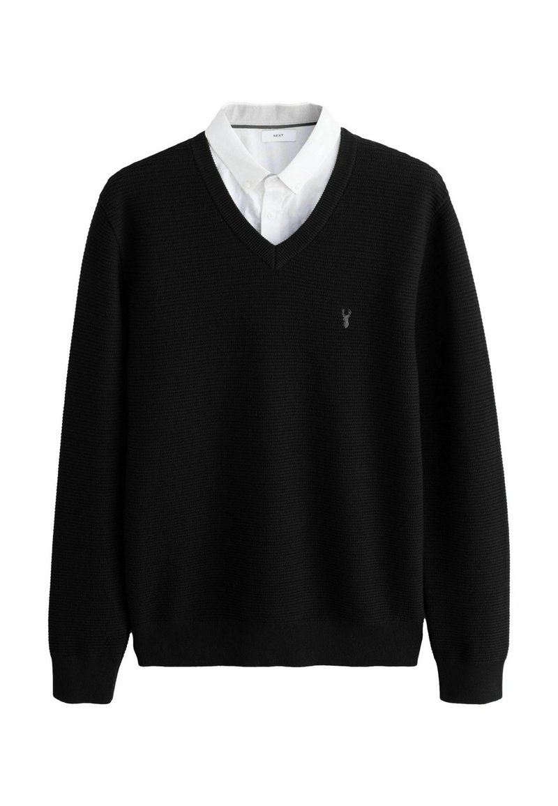 Schwarzer, gestrickter V-Ausschnitt-Pullover über einem weißen Hemd mit Kragen, mit einem kleinen Logo auf der linken Brust und gerippten Bündchen und Saum.