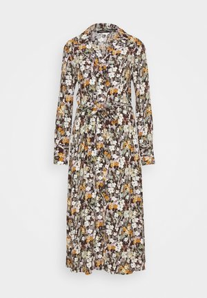 Bloemenjurk met lange mouwen, bruine basis en groene, witte, oranje en paarse bloemen. Heeft een taille met ceintuur en een kraag.