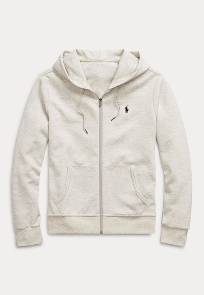 Ljusgrå zip-up-hoodie i mjukt tyg med känguruficka, dragsko i huvan och liten svart logotyp på vänster bröst.