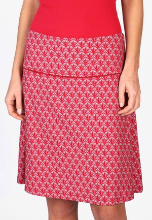 Red patterned skirt with a flared design, featuring a floral pattern of pink and green. Smooth fabric texture, with an elastic waistband.