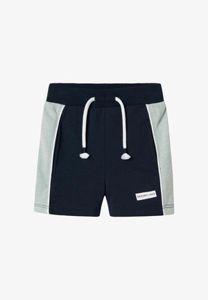Shorts bleu marine foncé avec des panneaux latéraux vert clair, une taille élastique, un cordon blanc, et une petite étiquette blanche portant la mention "DESERT LINES."