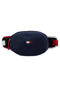 Granatowa nerka z gładkiej tkaniny, z czerwono-białym paskiem, małą naszywką z logo i zapięciem na zamek.