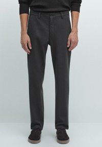 Dark gray trousers with a fitted design, featuring a flat front, belt loops, and a single button closure. Made from a smooth cotton blend.