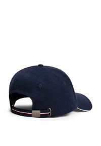 Gorra de béisbol azul marino vista desde la parte posterior, con una correa ajustable de rayas rojas, blancas y azul marino y un broche de metal.