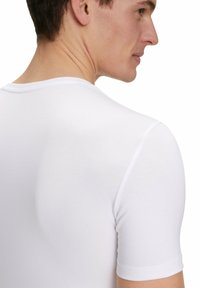 White short-sleeve t-shirt made from smooth, lightweight fabric. Features a classic crew neckline and a fitted design.