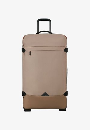 Large beige and brown soft-sided suitcase with telescopic handle, front zip pocket, compression straps, and Samsonite logo at the bottom center.
