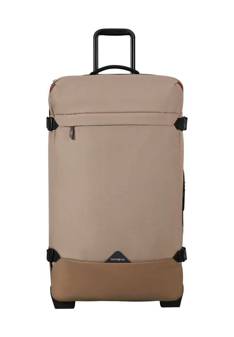 Large beige and brown soft-sided suitcase with telescopic handle, front zip pocket, compression straps, and Samsonite logo at the bottom center.