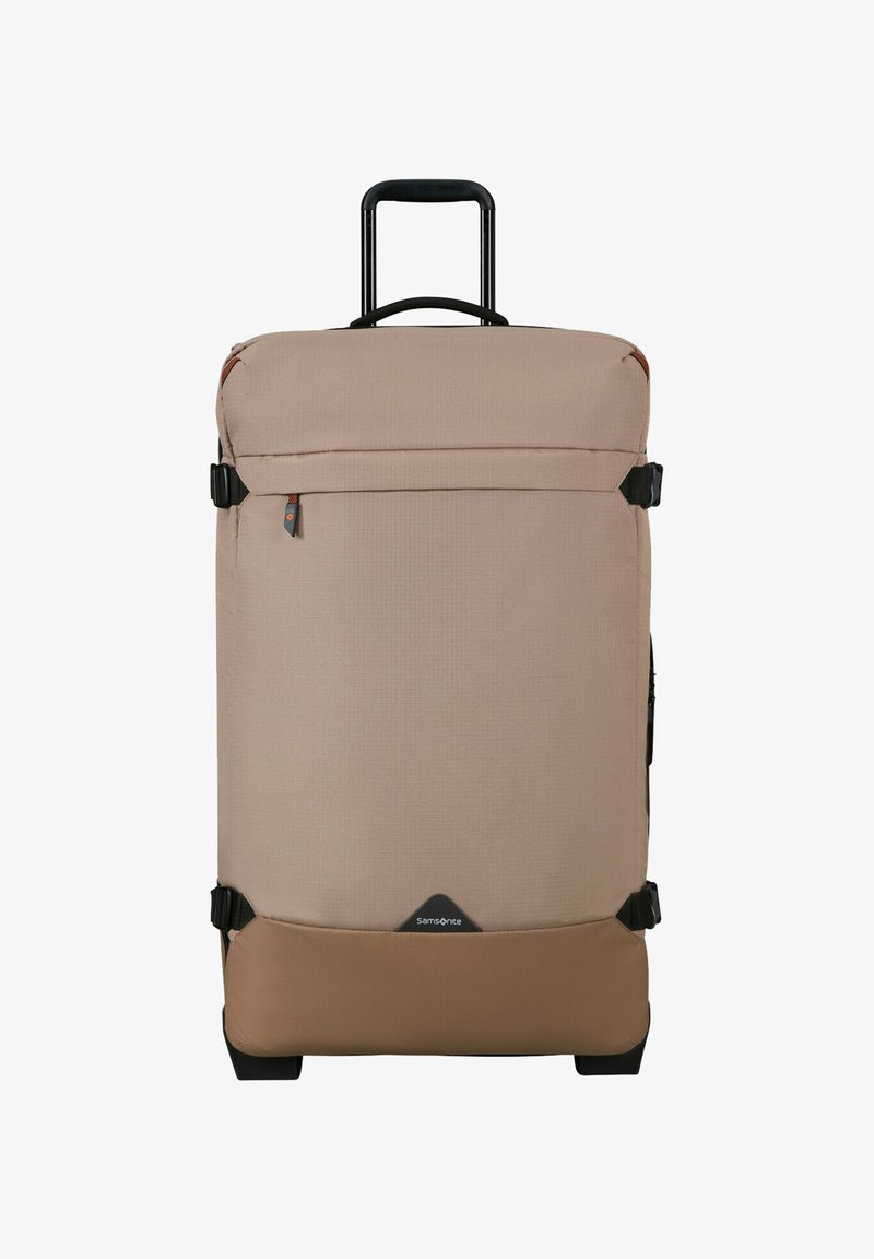 Large beige and brown soft-sided suitcase with telescopic handle, front zip pocket, compression straps, and Samsonite logo at the bottom center.