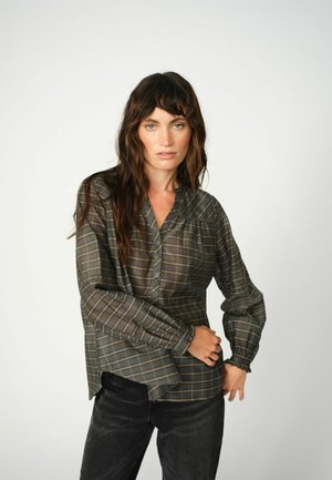 Button-up shirt in dark green and brown plaid, featuring long sleeves with gathered cuffs and a curved hem. Soft, lightweight fabric.
