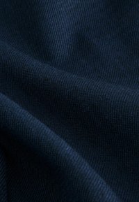 Dunkelblauer Stoff mit glatter Textur und geripptem Muster, das Falten und Tiefe zeigt. Eine Nahaufnahme hebt die Webdetails hervor.