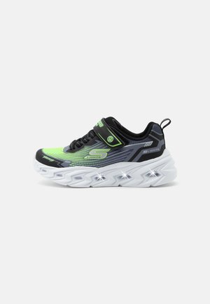 Black and neon green light-up sneaker with Velcro strap, chunky white sole, and illuminated midsole lights, designed for kids.