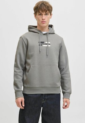 Gray hoodie with a front kangaroo pocket, drawstring hood, and "Jack & Jones" logo in black and cream on the chest. Soft texture, casual fit.