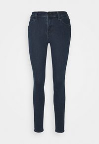 Jeans skinny azul oscuro de mezclilla, con diseño de cinco bolsillos, trabillas para cinturón y cremallera frontal. Textura suave, silueta ajustada.