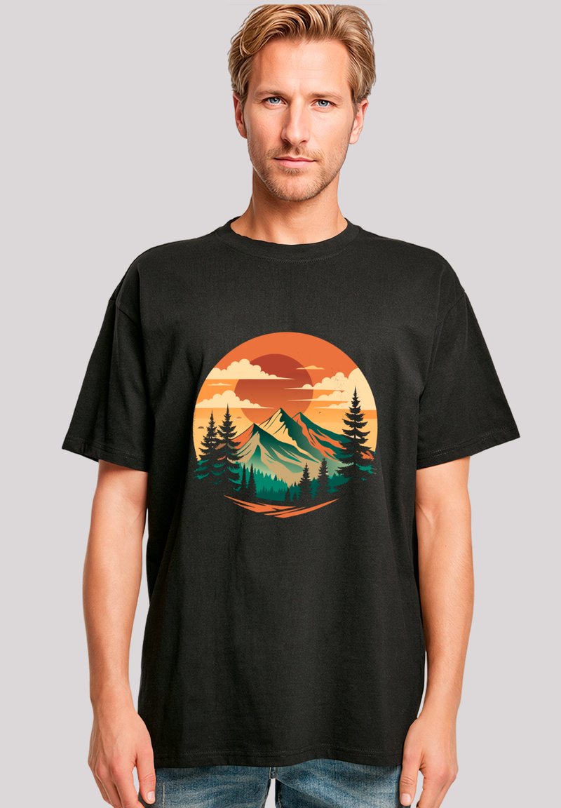 Schwarzes Baumwoll-T-Shirt mit einem runden Grafikdesign von Bergen, Bäumen und einem Sonnenuntergang in Orange, Gelb und Türkis.